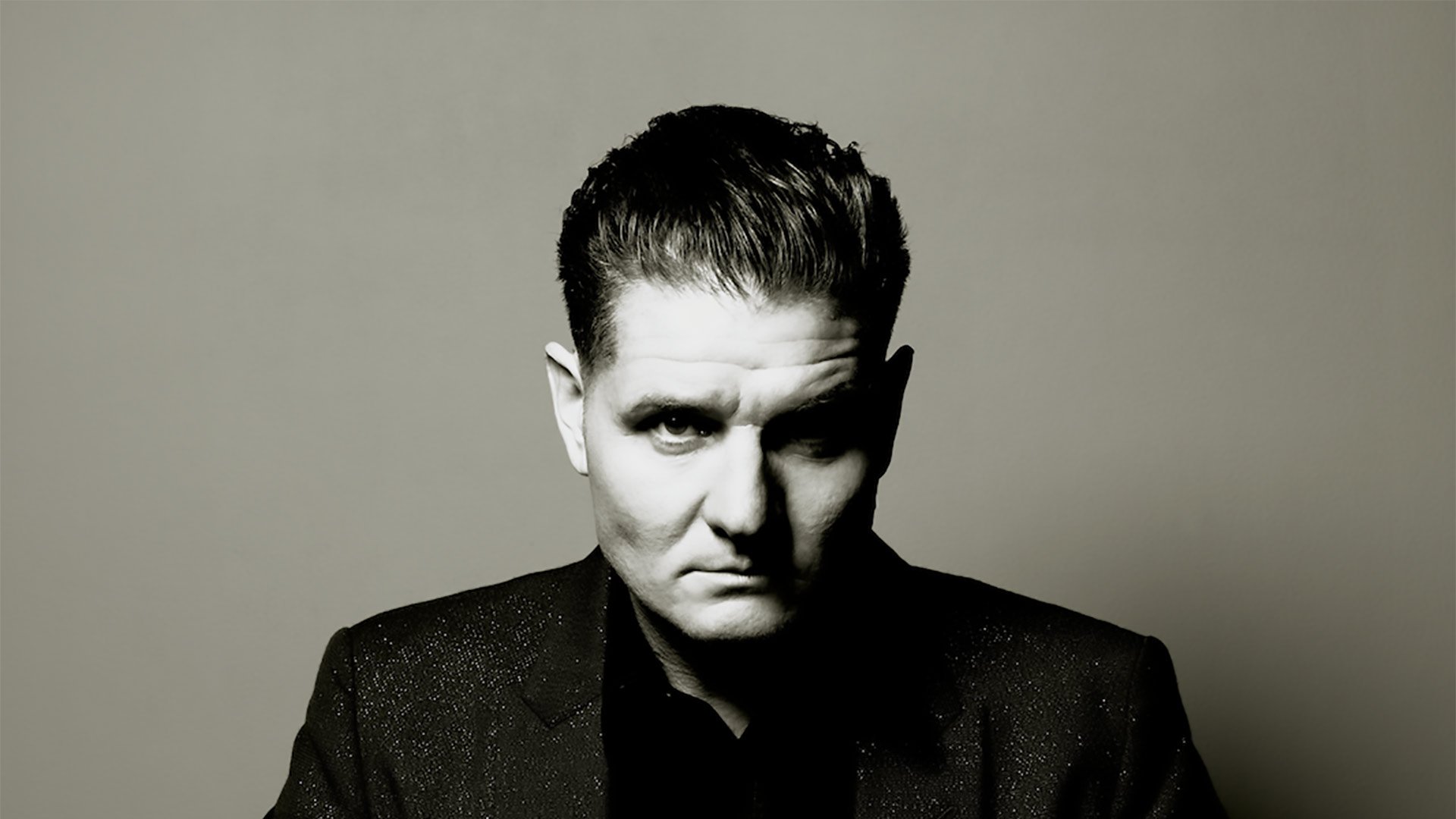 A classic black and white portrait capturing Douglas McCarthy's intense and polished demeanor.